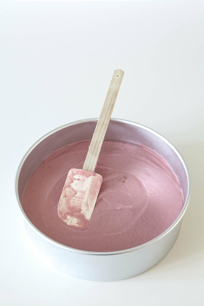 Smoothing the filling into the tin